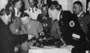 Hitler and Porsche look at VW model, 1936