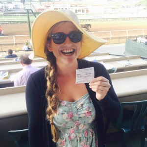 Julie Johnson holding a ticket at a horse race