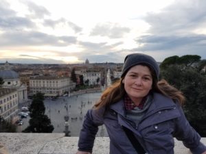 Robyn Fishman at an elevation with city behind her