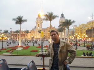 Mario Tumen with castle like building and garden in background