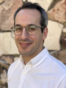 David Stein headshot with stone wall in background