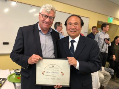 Professor Nelson Lichtenstein Given Top Honor pictured with another person and people mill about in the background