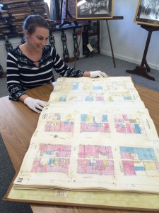 Christine Stokes displays a large document.