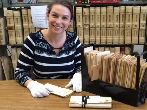 Christine Stokes carefully working with documents.