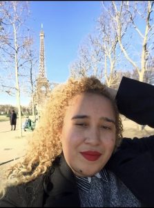 Tara Kendall headshot in front of the Eiffel Tower