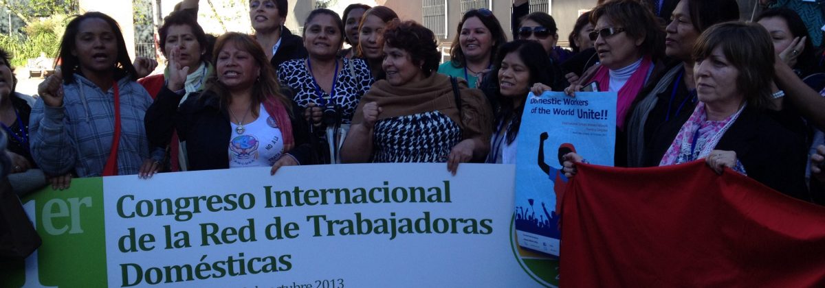 International Congress of Network of Domestic Workers protest with large poster and many women