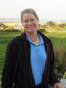 Laura Voisin George with field and houses behind her