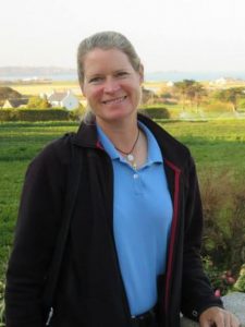 Laura Voisin George with field and houses behind her