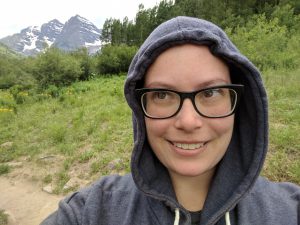 Kristen Thomas-McGill with greenery and mountains in background
