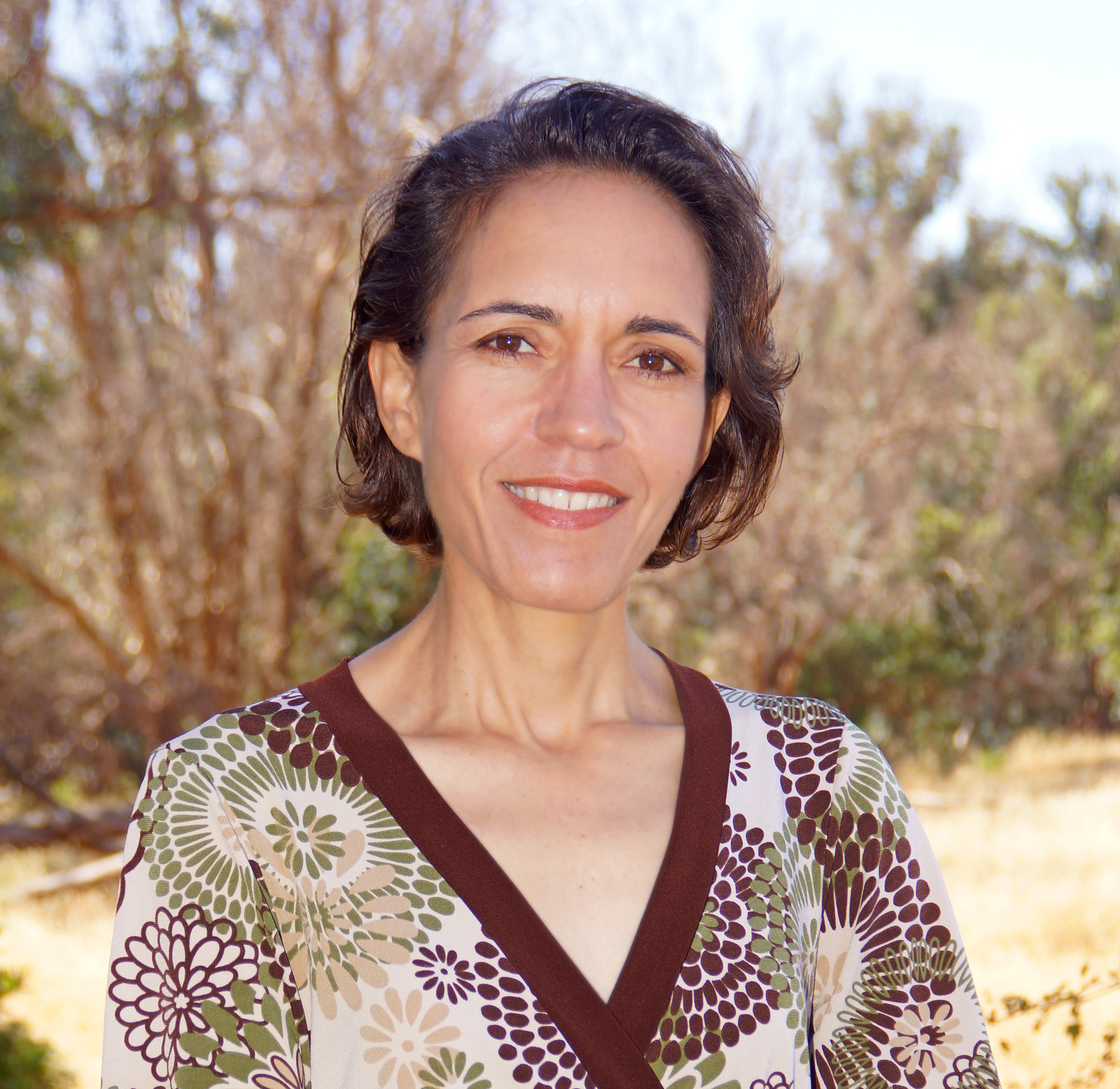 Miroslava Chavez-Garcia headshot in front of trees and greenery