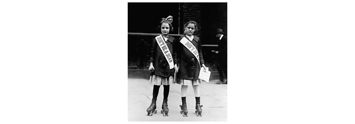 Roller skaters with socialist leaflets, "Don't be a scab"