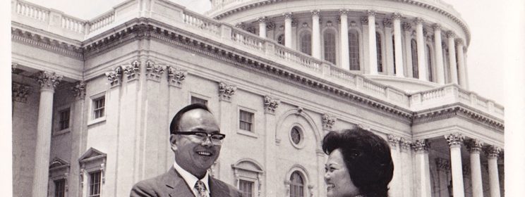 Black and white photo of Sam Lee outside the U.S. capitol shaking hands with Patsy T. Mink. Signed by Mink, to Lee.