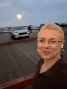 Woman in a dress holding a chicken