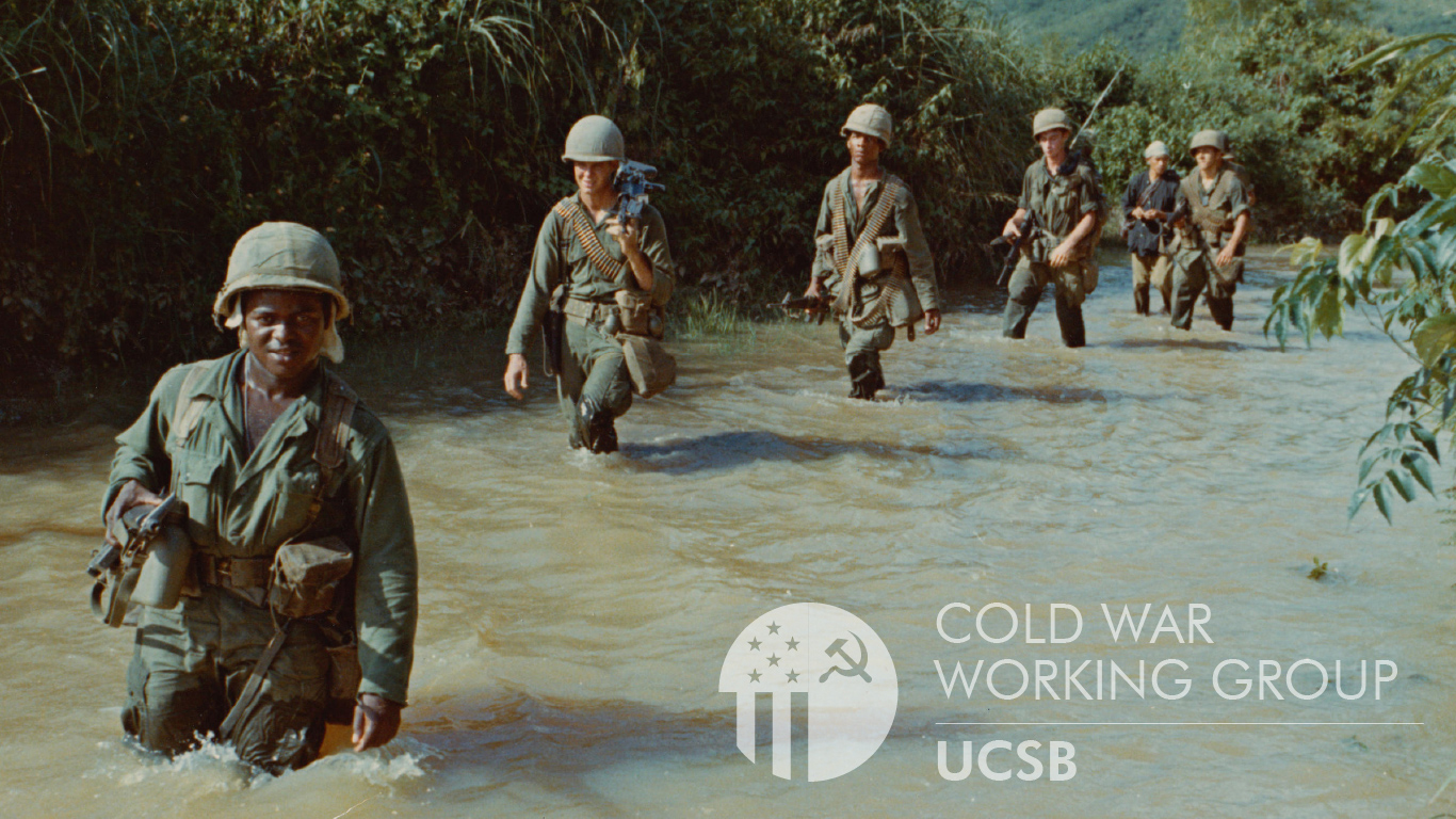 6 people in camoflauge uniform wading in a river. UCSB Cold War Working Group
