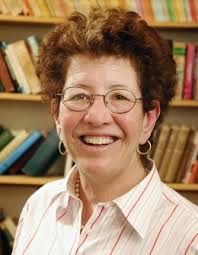 Laura Kalman headshot with bookcase filled with books in the background