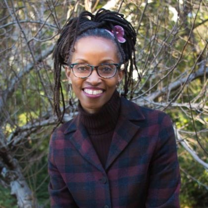 Ula Taylor headshot with branches and tree in background