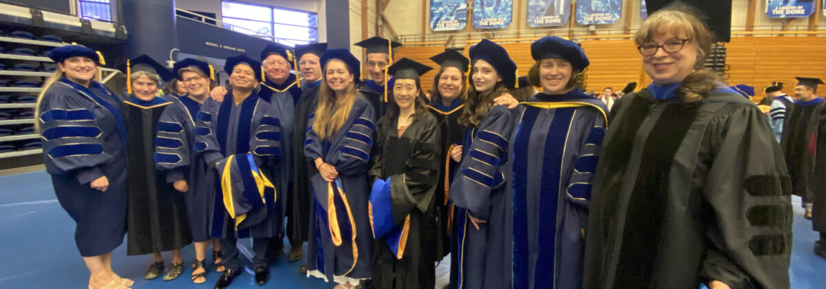 Graduates and faculty standing in line in the Thunderdome